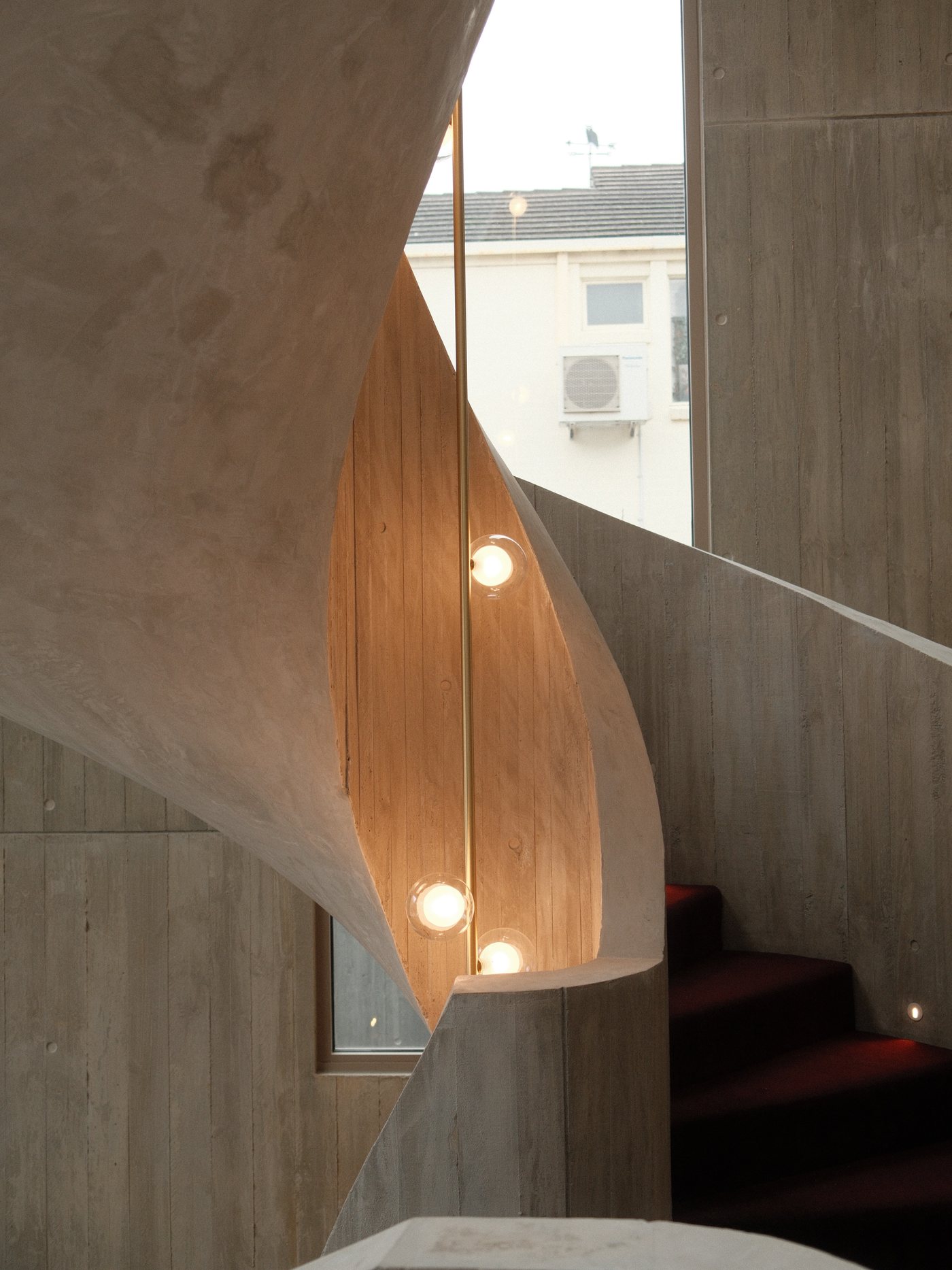 Curved concrete stair, rectified and finished with an architectural coating