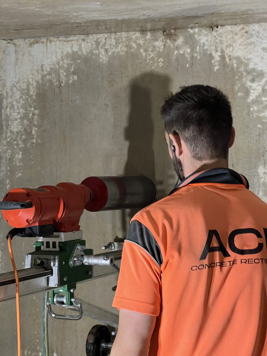 Core drilling a penetration through an existing shotcrete wall